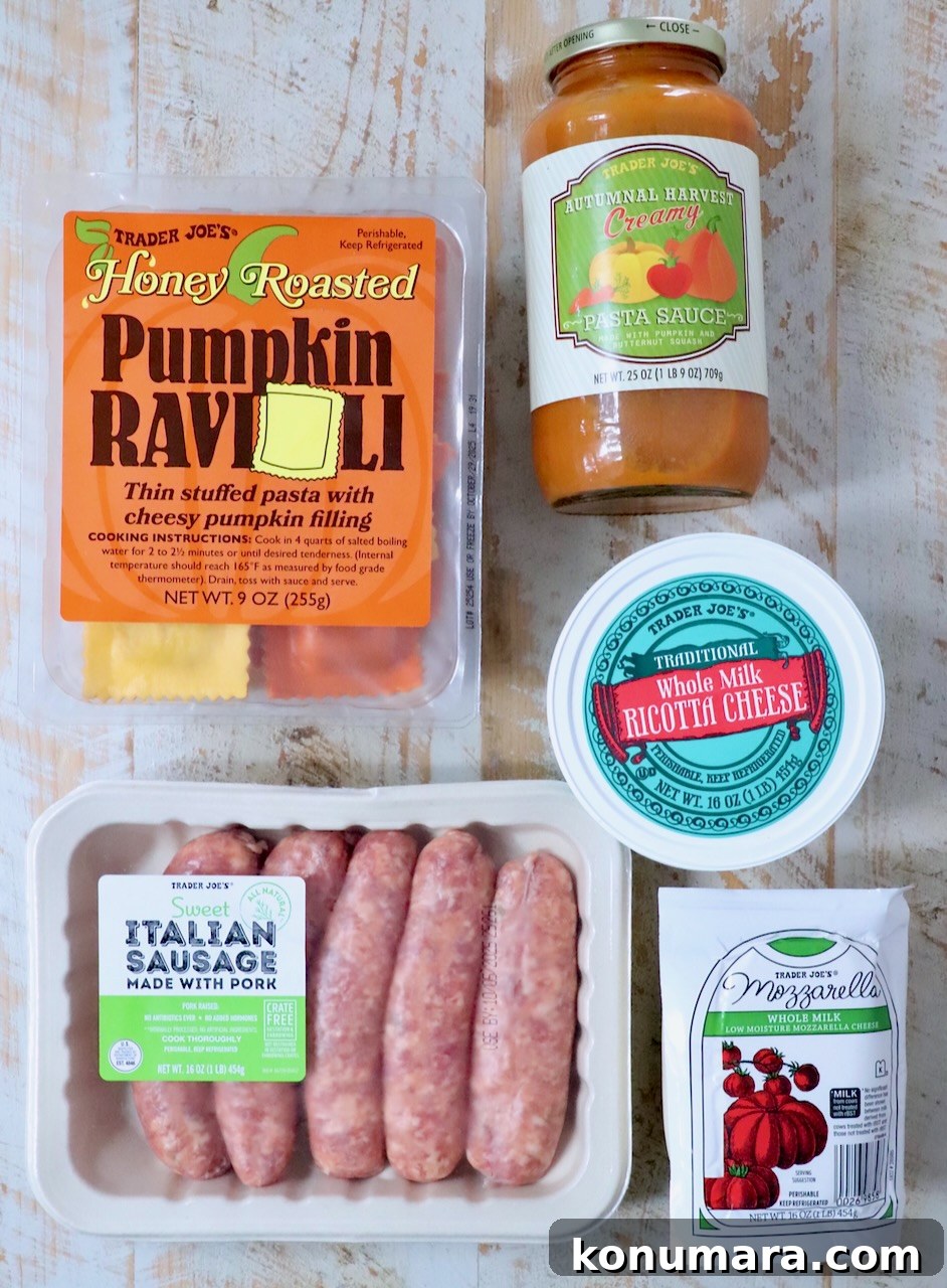 Baked Butternut Squash Ravioli with Brown Butter and Sage 3 Trader Joe's ingredients on a wooden surface: Honey Roasted Pumpkin Ravioli, Autumnal Pasta Sauce, Sweet Italian Sausage, Ricotta Cheese, Mozzarella.