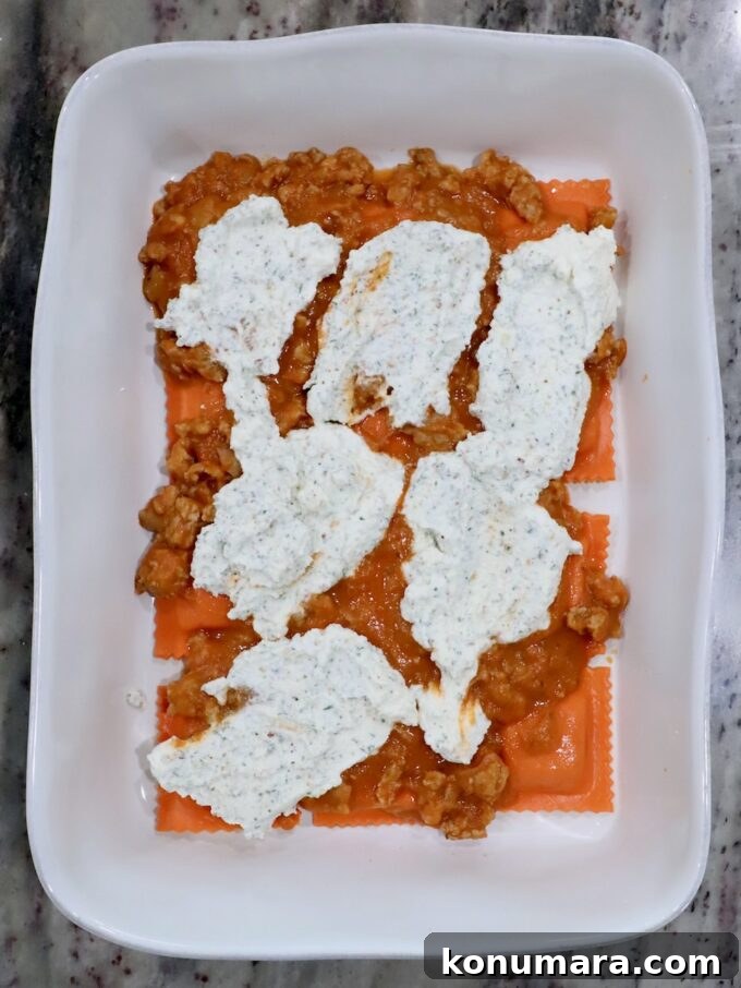 Baked Butternut Squash Ravioli with Brown Butter and Sage 8 pumpkin ravioli in a baking dish, topped with butternut squash meat sauce and seasoned ricotta cheese