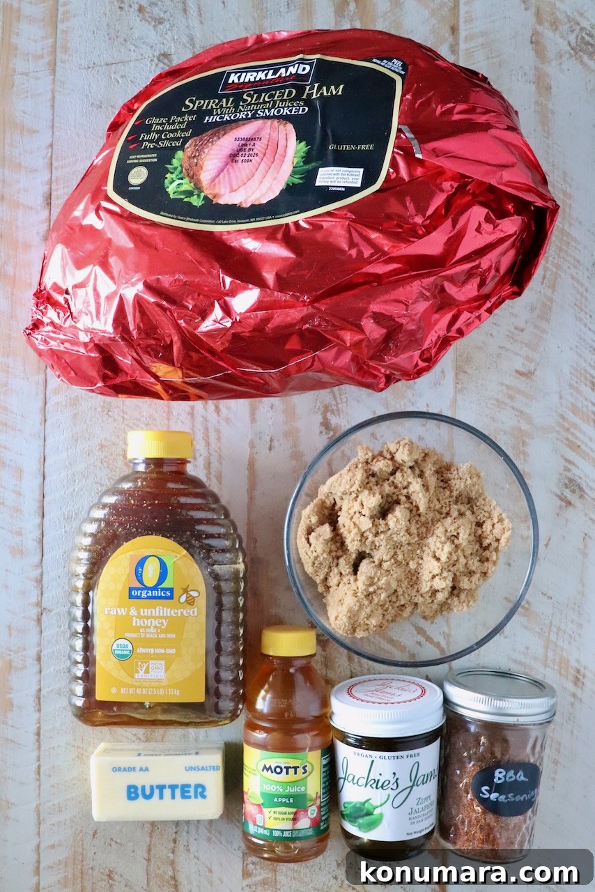 How to Smoke a Ham: Glaze, Time, and Temperature 3 A collection of ingredients for ham on a wooden surface. Included are a large wrapped ham, brown sugar, honey, apple juice, butter, jam, and seasoning.