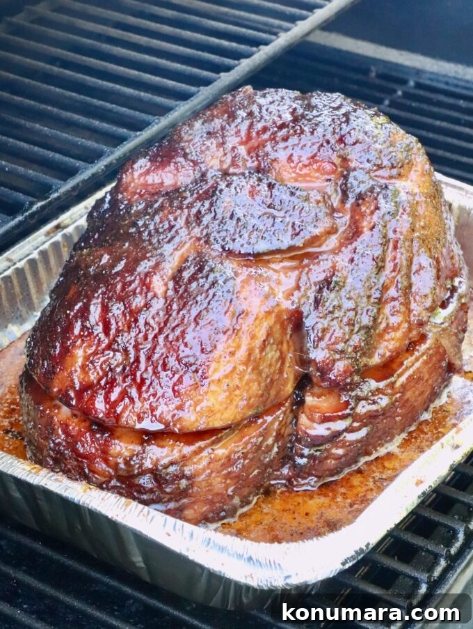 How to Smoke a Ham: Glaze, Time, and Temperature 10 Smoked ham with a glossy, caramelized glaze sits in a foil tray on a smoker