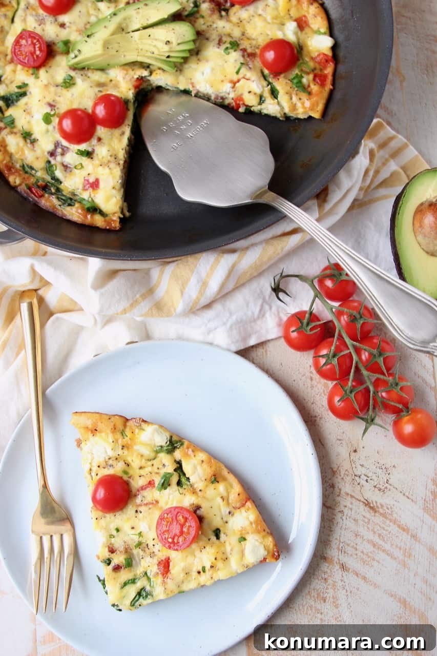 Slice of frittata on plate, next to frittata in skillet