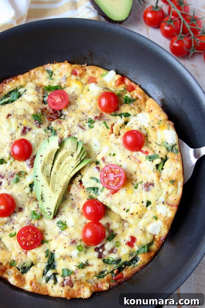 Slice being taken out of a frittata in the skillet