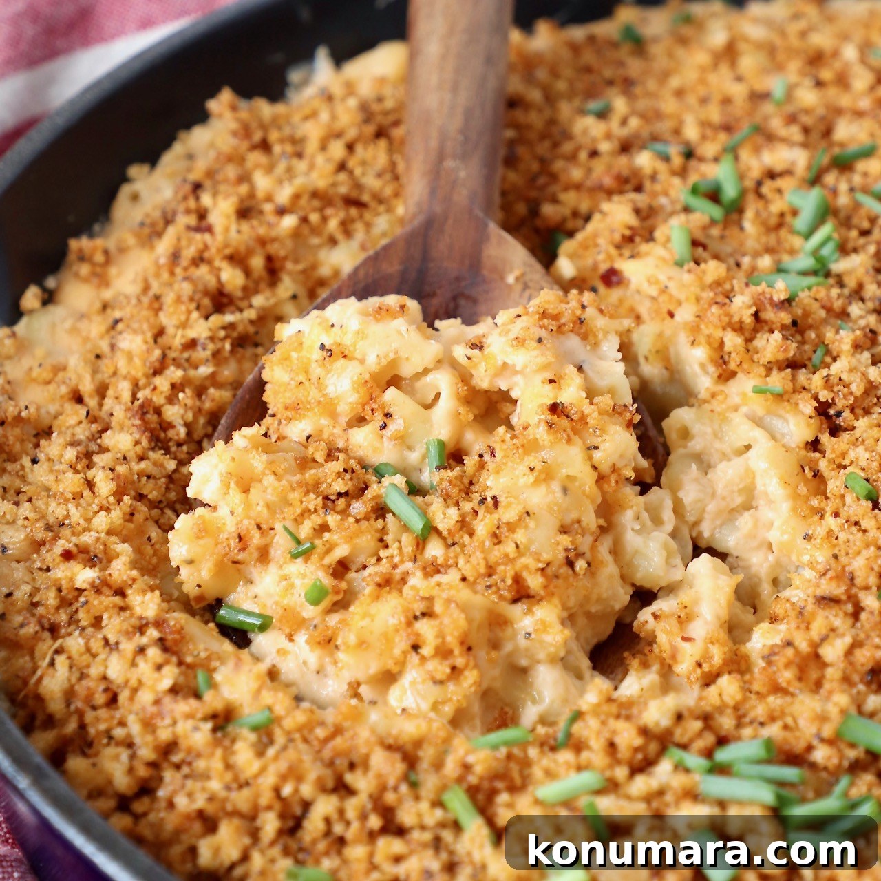 mac and cheese in skillet with serving spoon