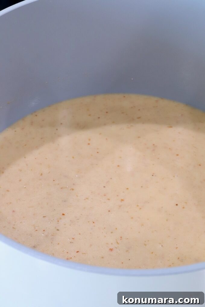 Curry Queso Dip Recipe 5 creamy red curry sauce in a pot