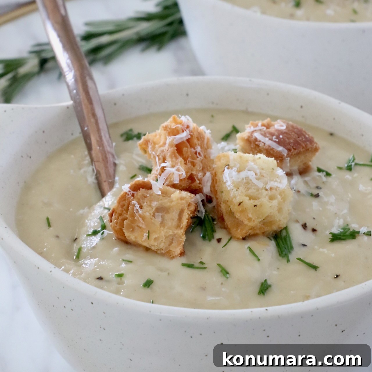 parsnip soup in bowl topped with croutons