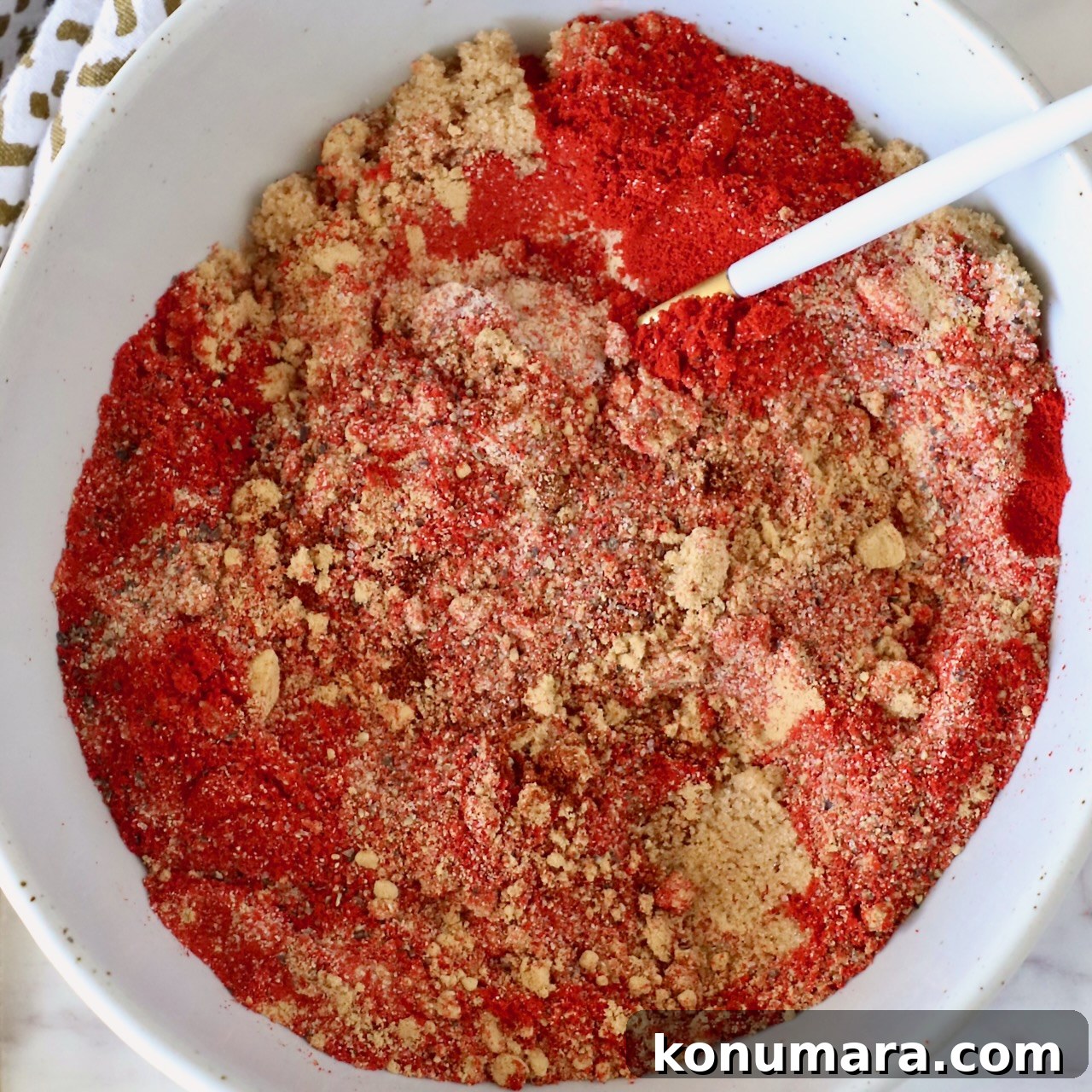 brown sugar and spices mixed together in a bowl with a spoon