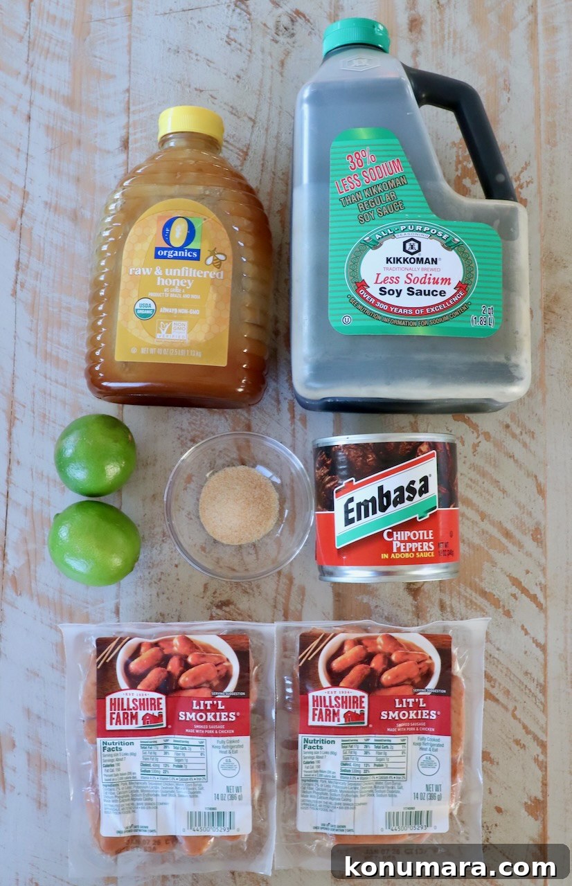 Chipotle Honey Glazed Little Smokies 3 Assorted ingredients on a wooden surface include honey, low-sodium soy sauce, chipotle peppers, brown sugar, limes, and two packs of Lit'l Smokies sausages.