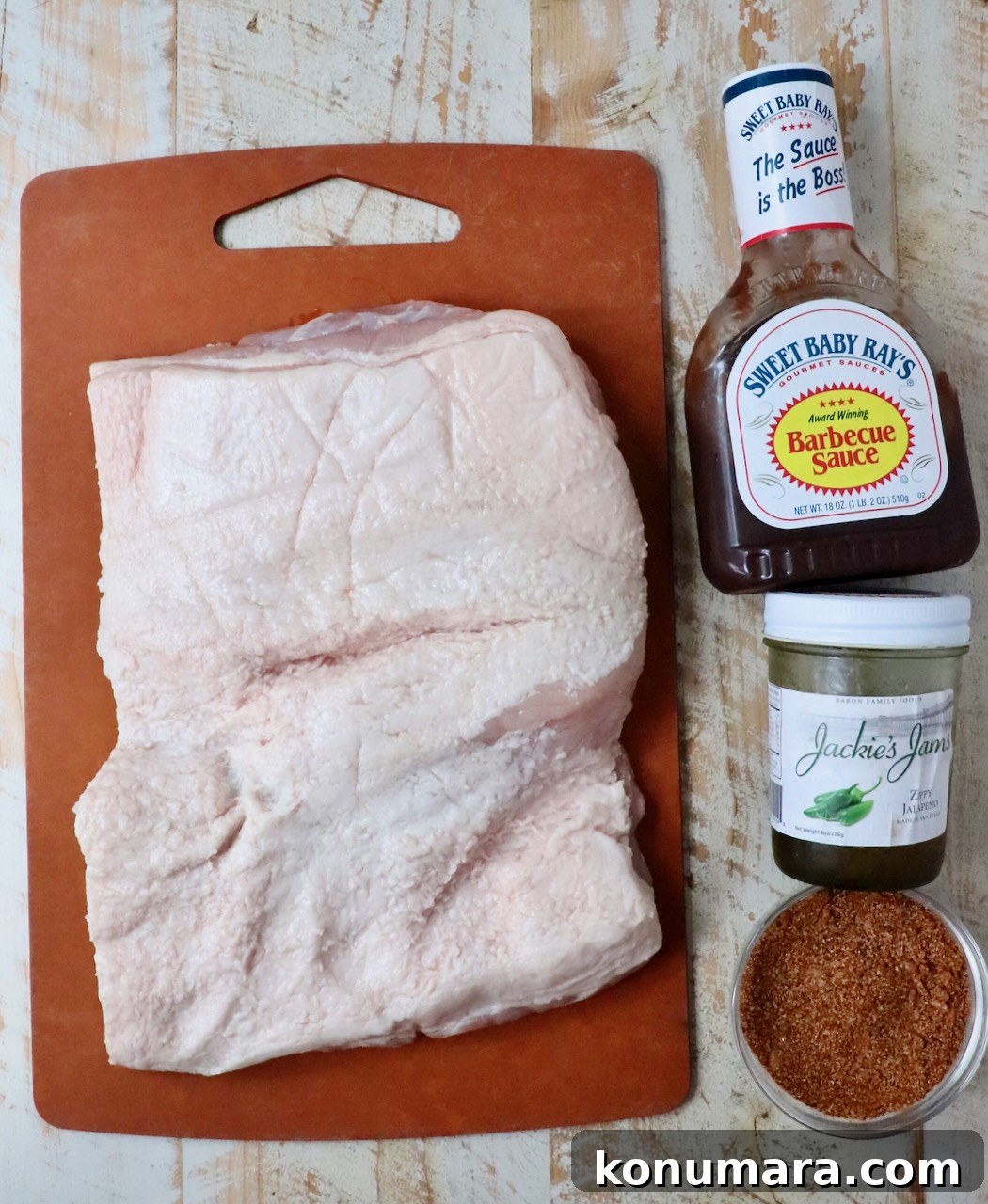 ingredients for smoked pork belly burnt ends on a white wood board