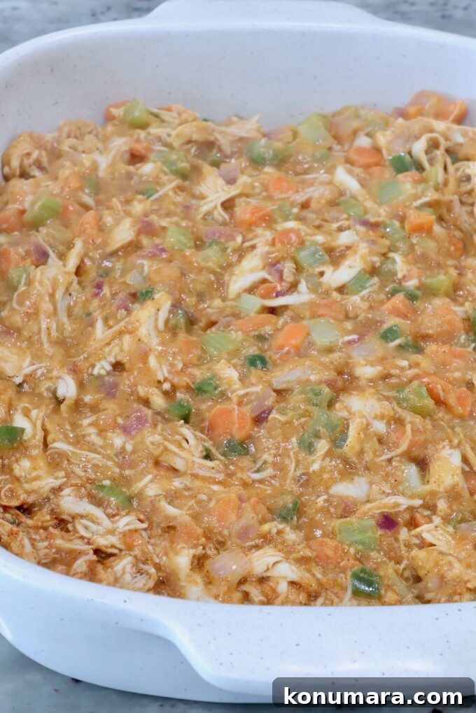 buffalo chicken pot pie filling in a baking dish