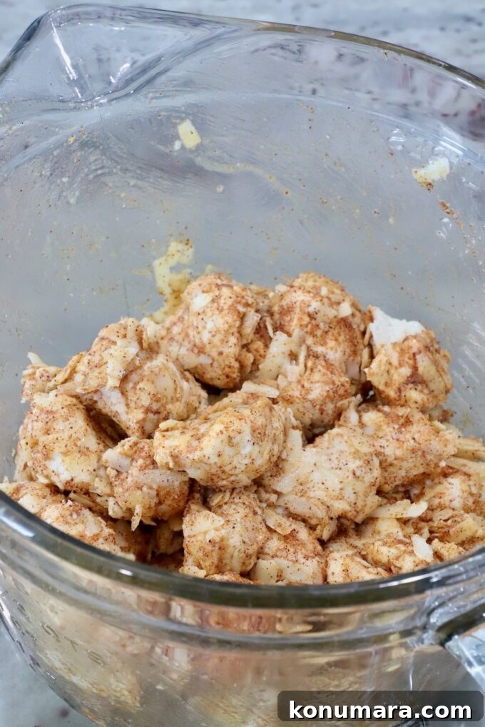 seasoned cubes of uncooked biscuit dough in a glass bowl