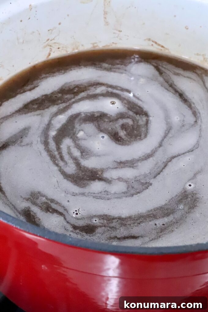 beef stock simmering in a pot