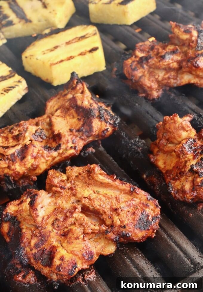 How to Make Chicken Al Pastor Tacos with Pineapple 5 grilled marinated chicken thighs and pineapple slices on a grill