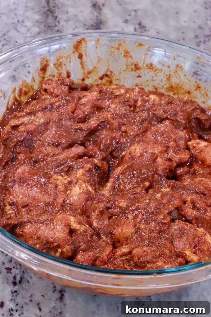 Slow-Roasted Al Pastor Pork Tacos 4 Thinly sliced pork tossed in a spicy Mexican marinade in a glass bowl