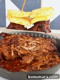 Slow-Roasted Al Pastor Pork Tacos 8 A stack of marinated, cooked pork layered on skewers, topped with pineapple slices, in a cast iron skillet. A knife slices through the juicy, cooked meat.