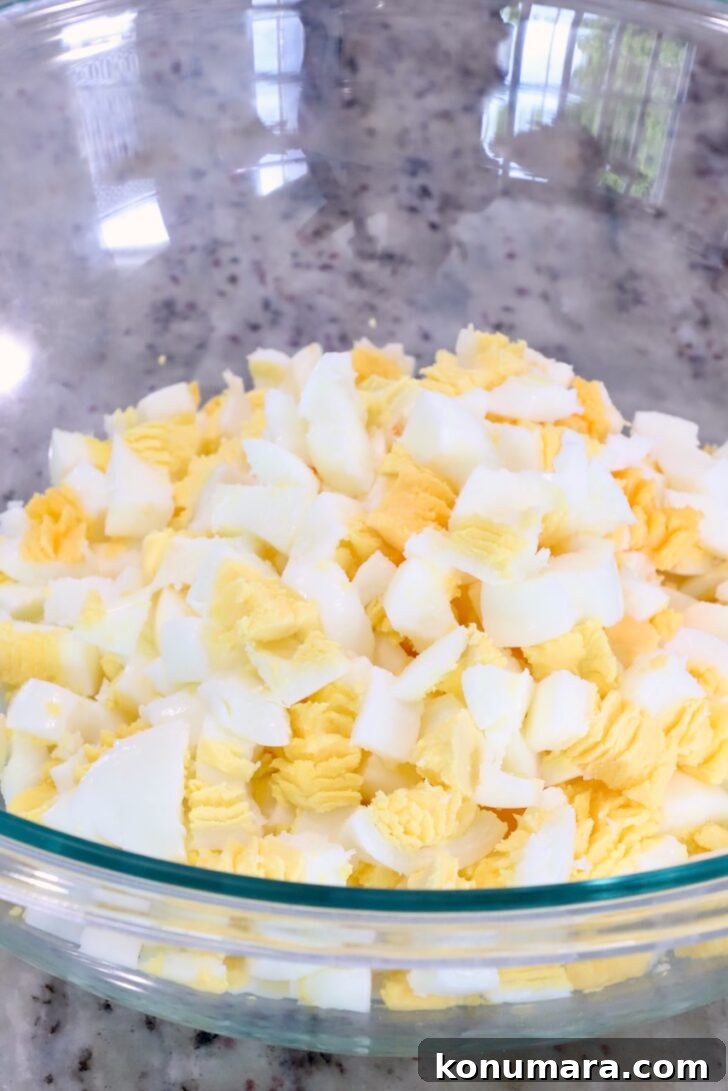 Spicy Miso Egg Salad with Chili Crisp Recipe 7 diced hard boiled eggs in a large glass bowl