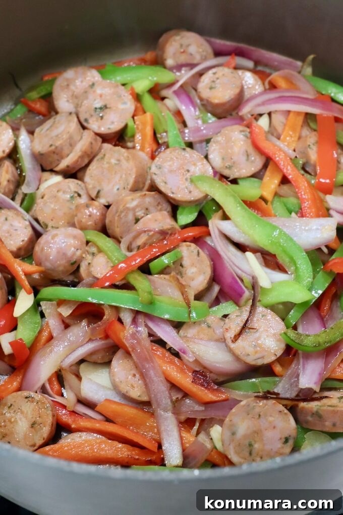 Classic Italian Sausage and Peppers Recipe 4 sliced Italian sausage and bell peppers in a large pan