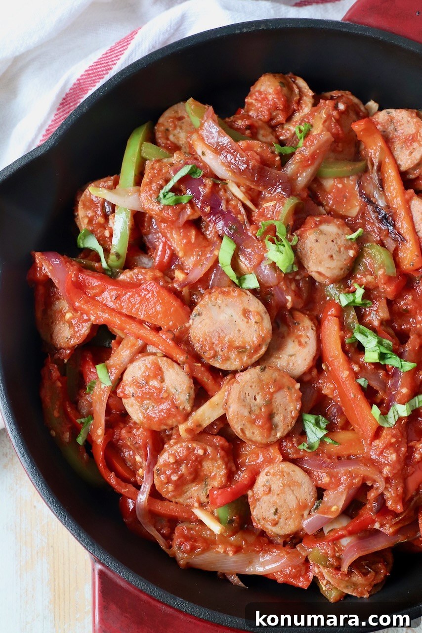 Classic Italian Sausage and Peppers Recipe 7 sliced sausage and peppers in tomato sauce in skillet