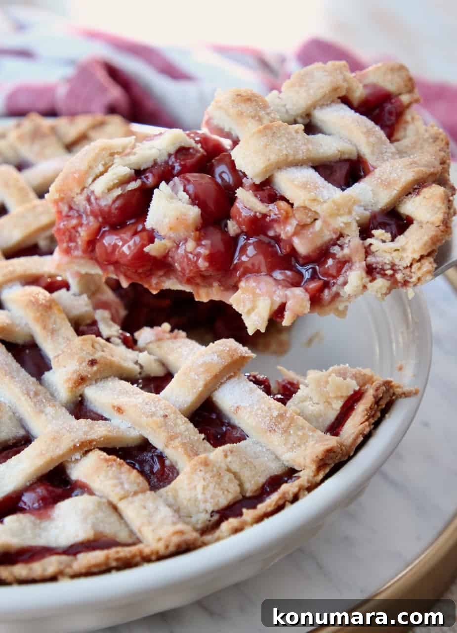 slice of cherry pie lifted out of pie plate