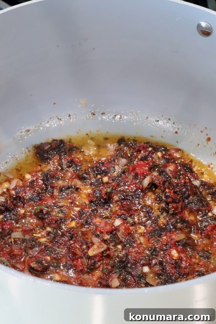 sun dried  tomatoes mixed with melted butter and seasonings in a saucepan