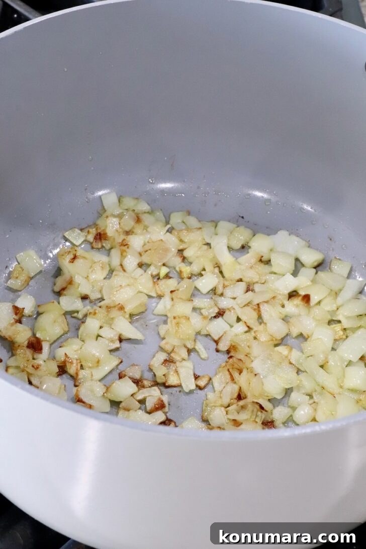 cooked, diced onions in a large pot on the stove