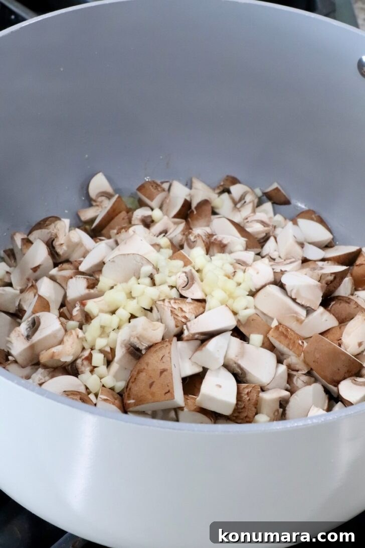 diced mushrooms and minced garlic in a pot on the stove