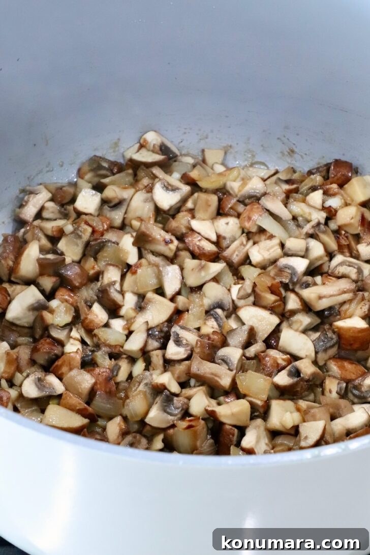 cooked diced mushrooms in a pot on the stove