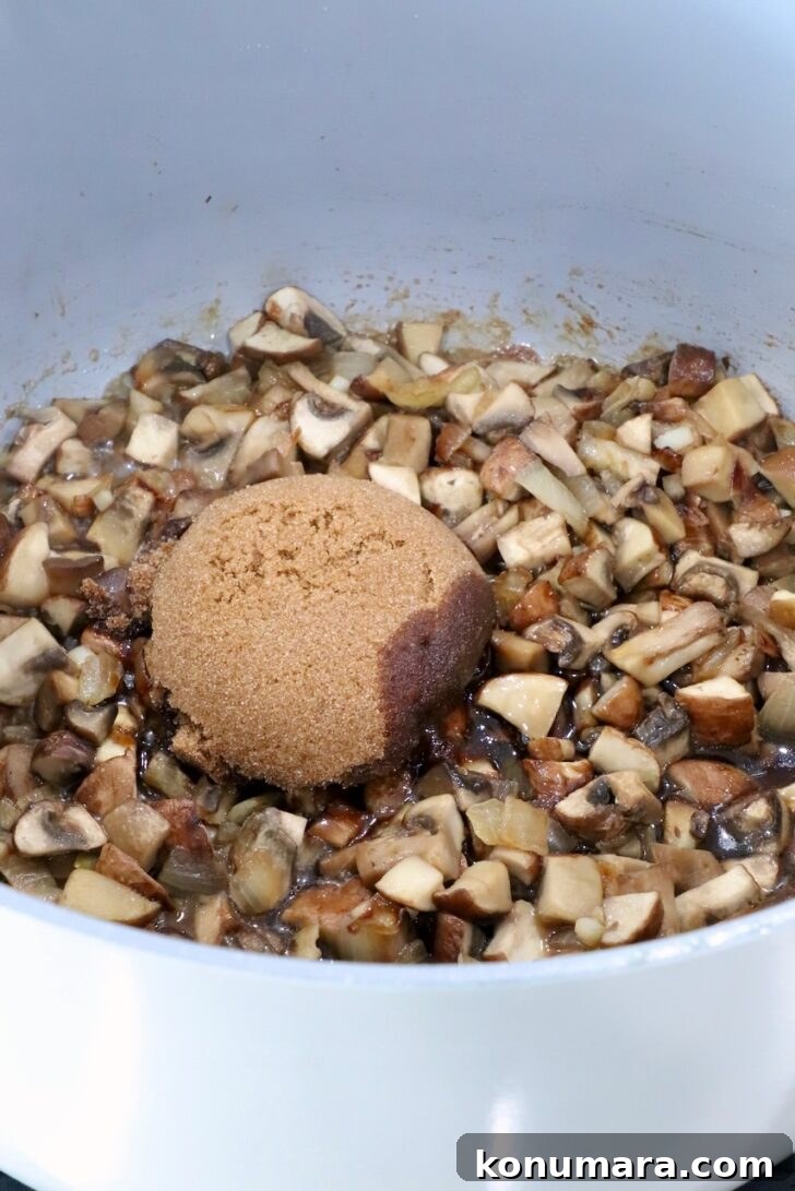 cooked diced mushrooms in a pot on the stove with brown sugar