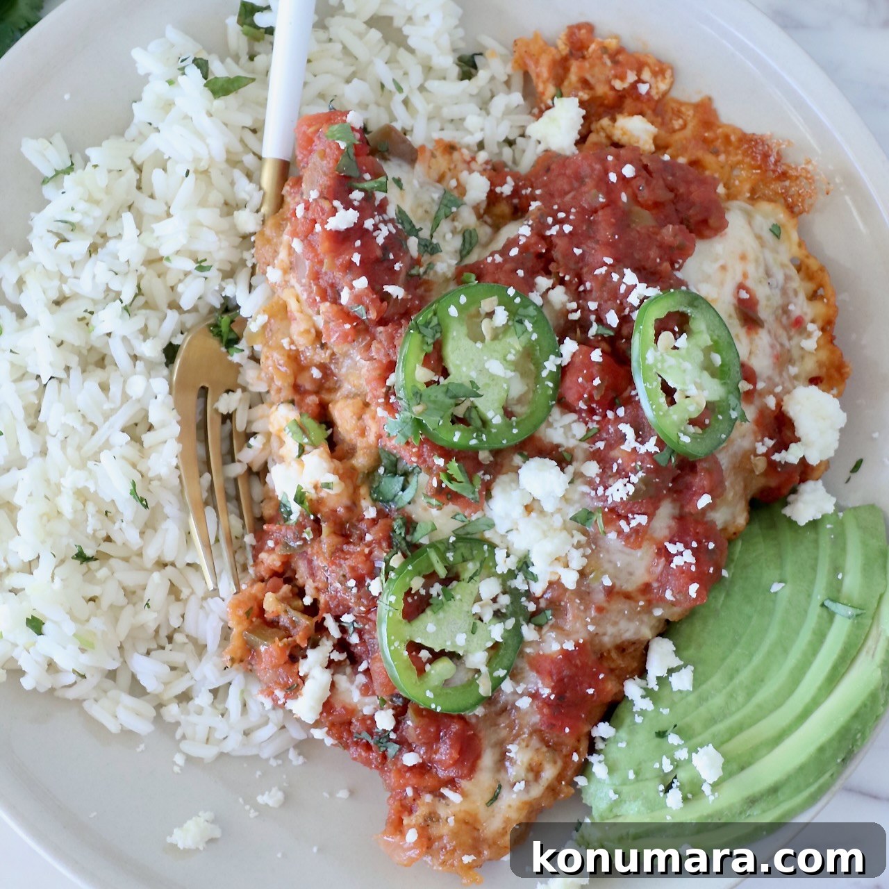 Mexican chicken parmesan topped with salsa and jalapeños