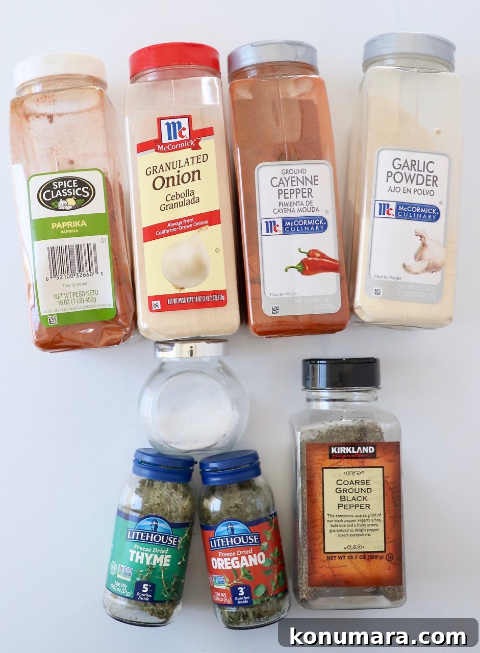 dried herbs and spices in plastic containers on a white surface