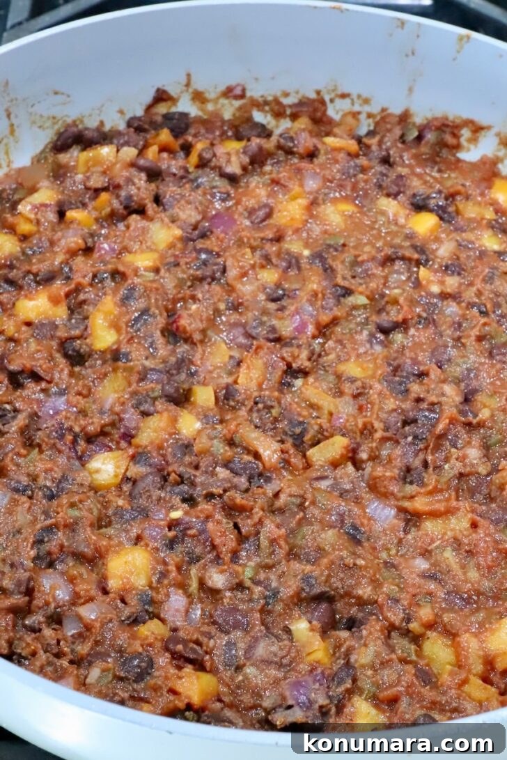 Vegetarian Cheesy Bean and Rice Burrito Recipe 8 bean burrito filling in a skillet
