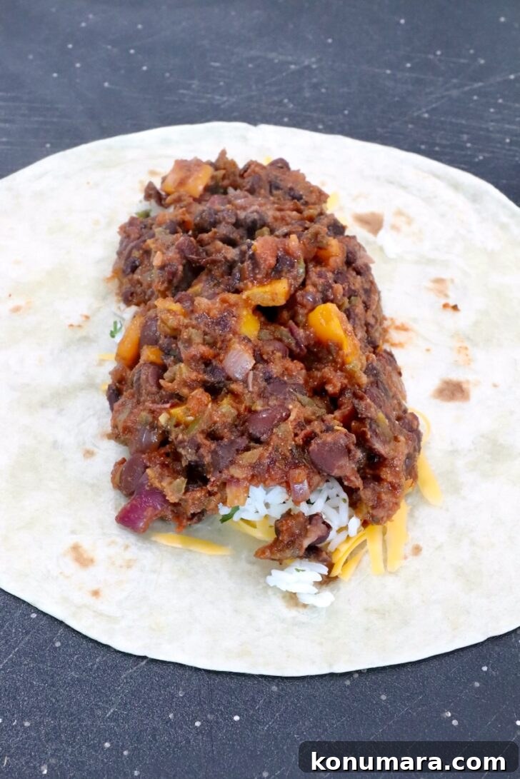 Vegetarian Cheesy Bean and Rice Burrito Recipe 10 bean filling in the middle of a tortilla