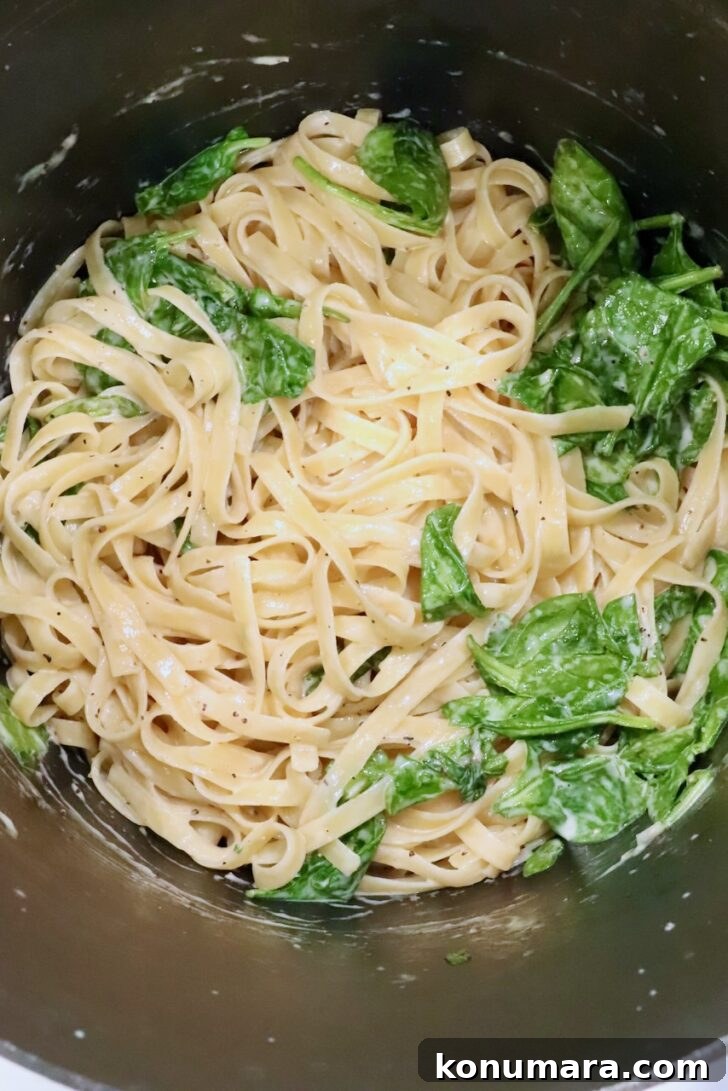Creamy Chicken Caesar Pasta with Parmesan and Croutons 11 pasta noodles in a large pot tossed with a creamy sauce and spinach