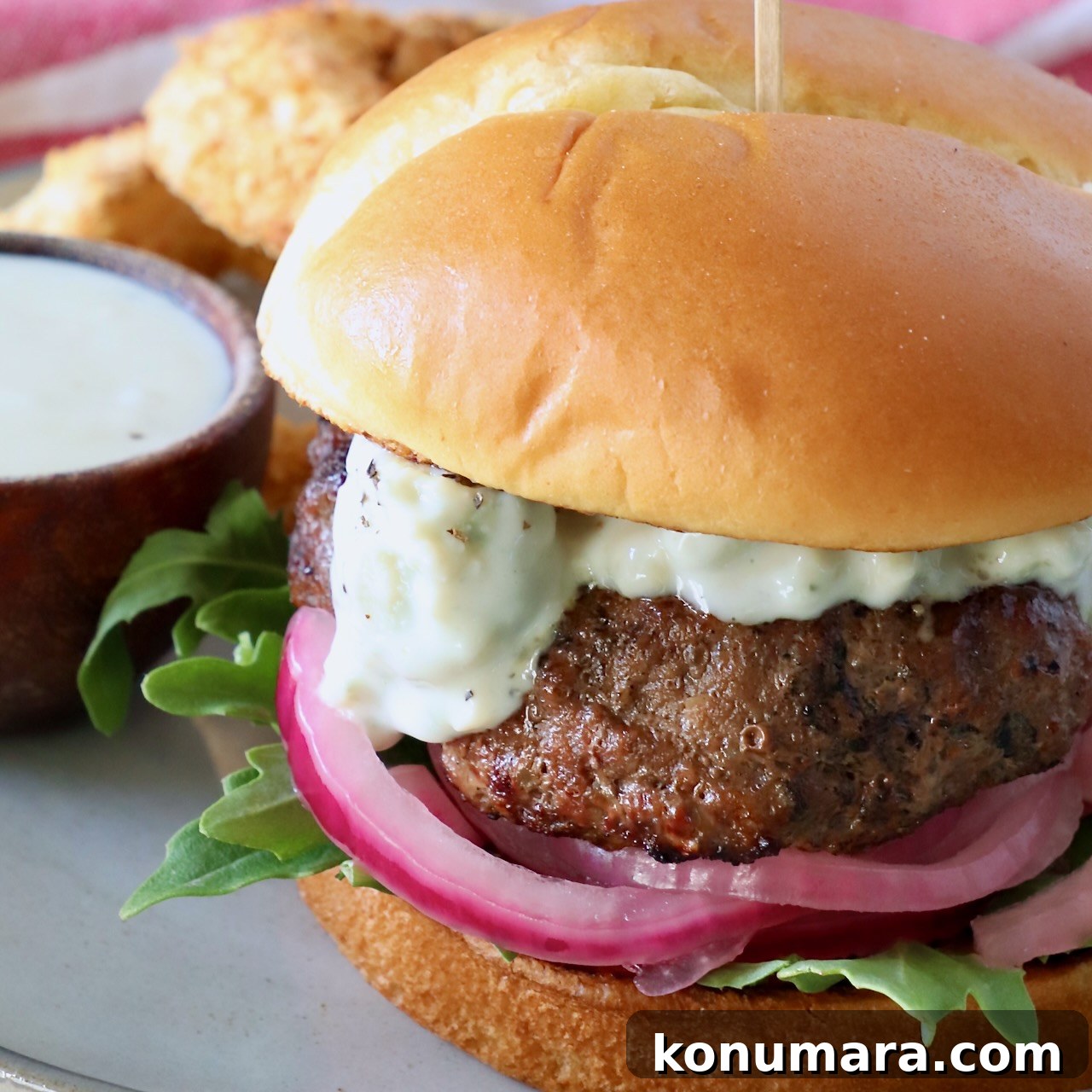 burger on plate with pickled onions and blue cheese