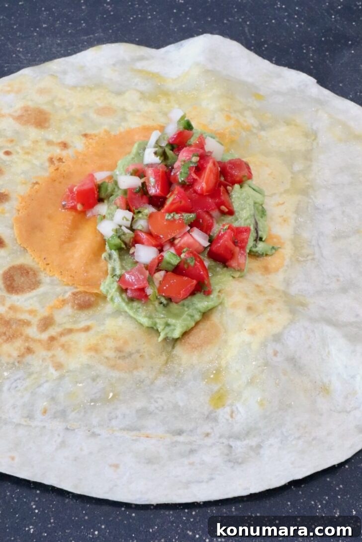guacamole and pico de gallo in the middle of a tortilla