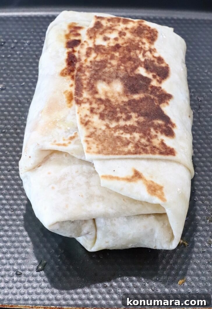 crispy toasted burrito on a griddle pan