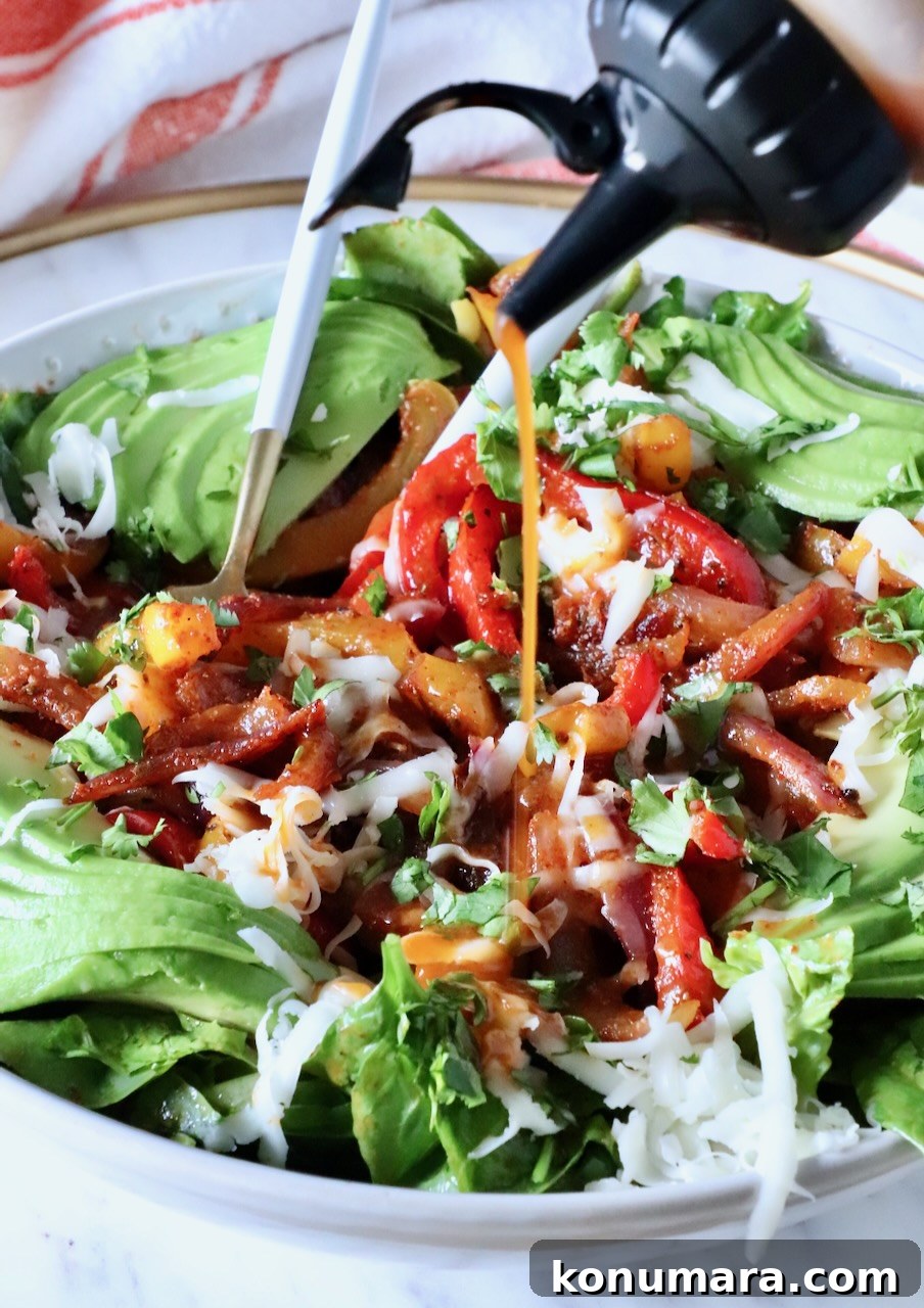 Zesty Chipotle Salad with Avocado, Corn and Lime 6 chipotle vinaigrette dressing poured over a salad in a bowl