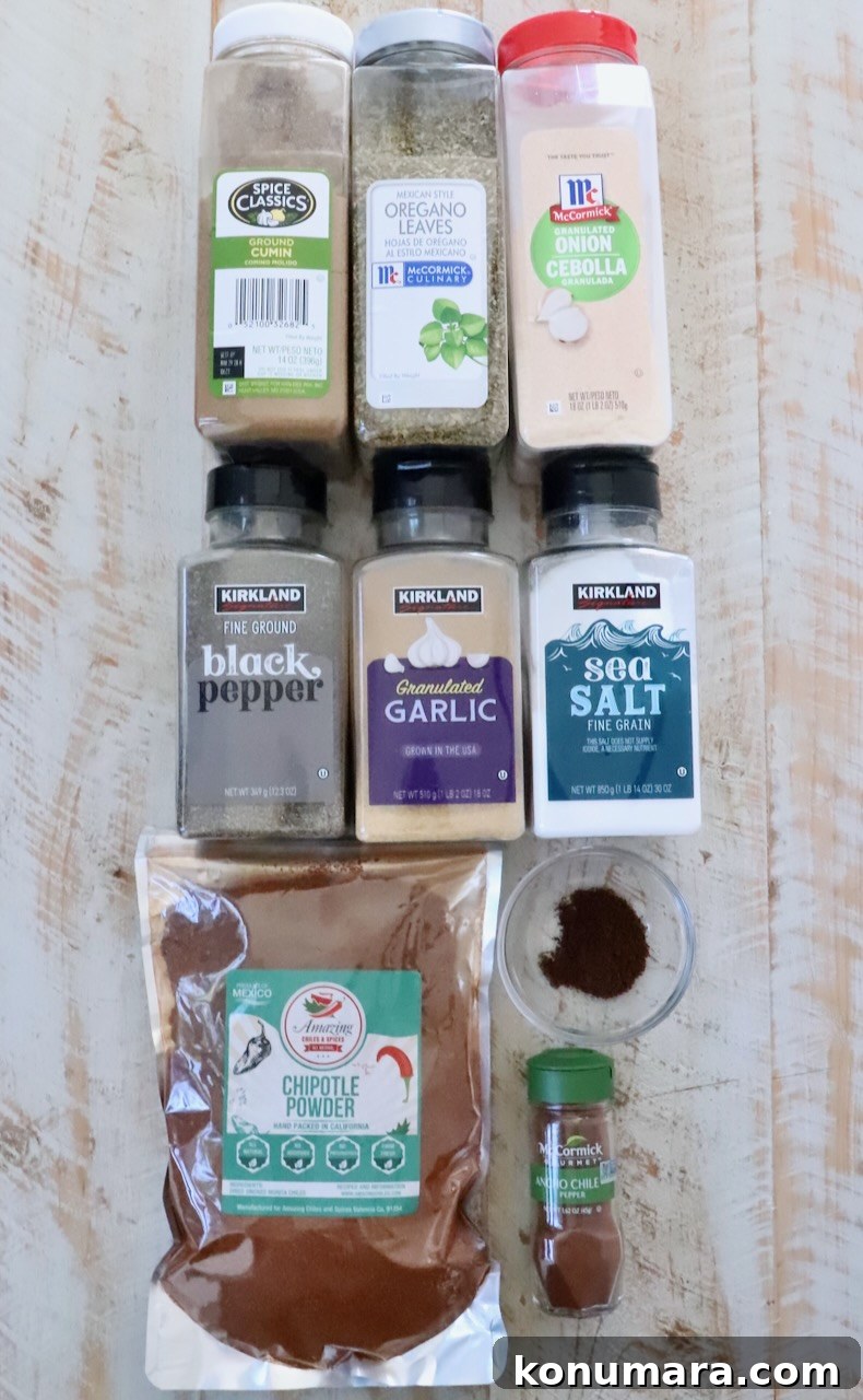 spices in plastic containers lined up on a white wood board