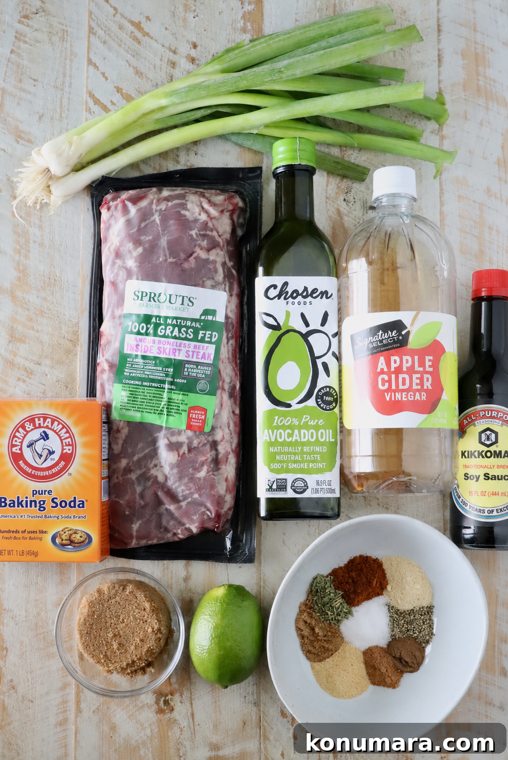 ingredients for jerk steak on a white wood board