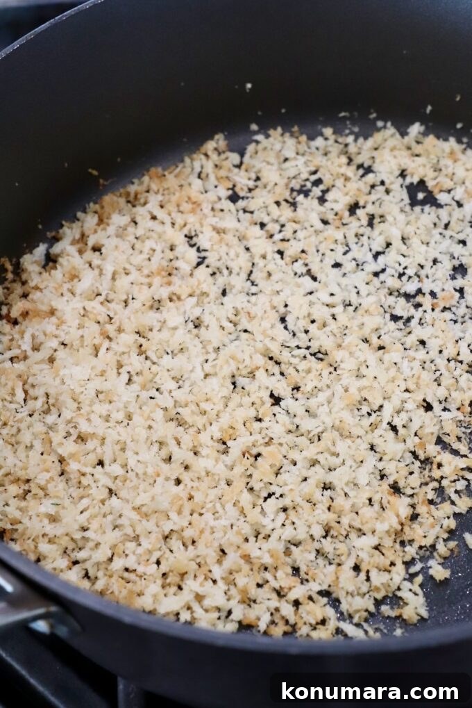 Creamy Dill Pickle Pasta Recipe 8 toasted breadcrumbs in skillet on stove