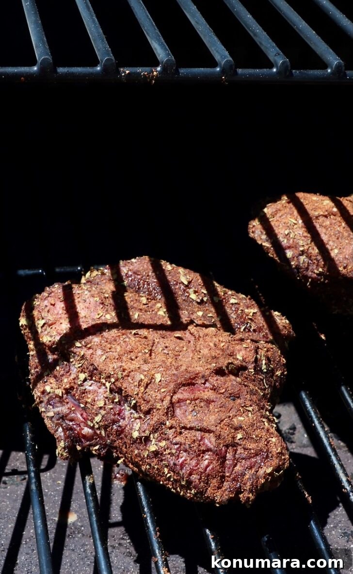 seasoned beef cheeks on a smoker