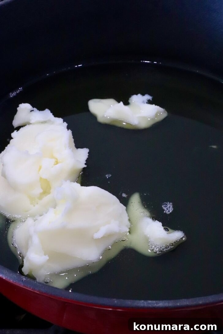 beef tallow melting in a cast iron skillet
