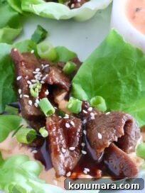 Korean Beef Bulgogi Lettuce Wraps Recipe 11 korean bbq sliced beef in a lettuce wrap with a creamy gochujang sauce on a plate