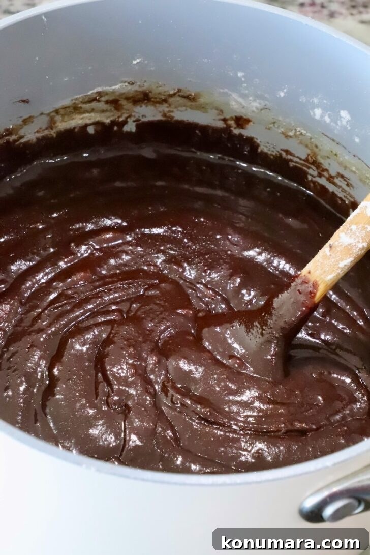 brownie batter in a pot with a spatula