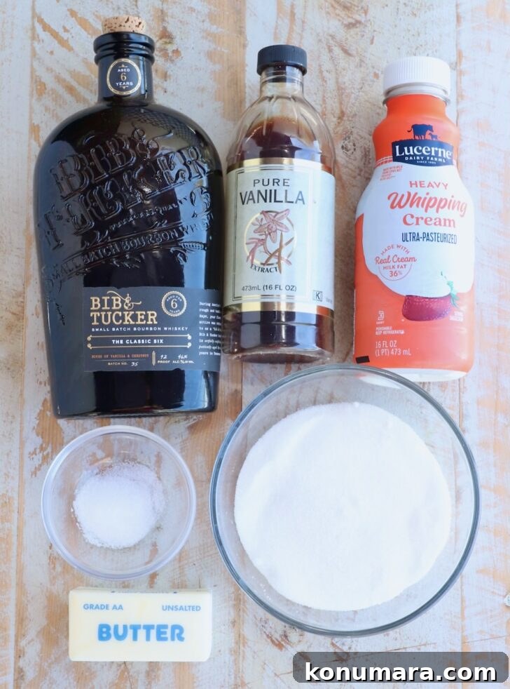 ingredients for bourbon caramel sauce on a white wood board