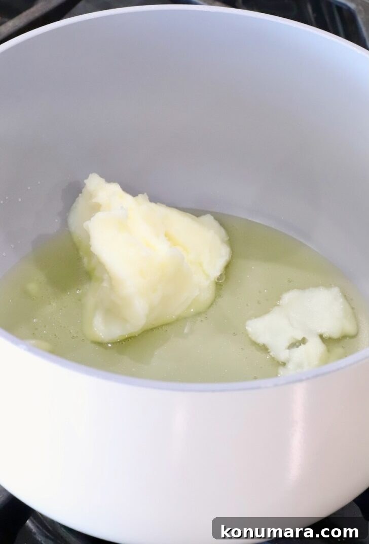 melting beef tallow in a pot on the stove