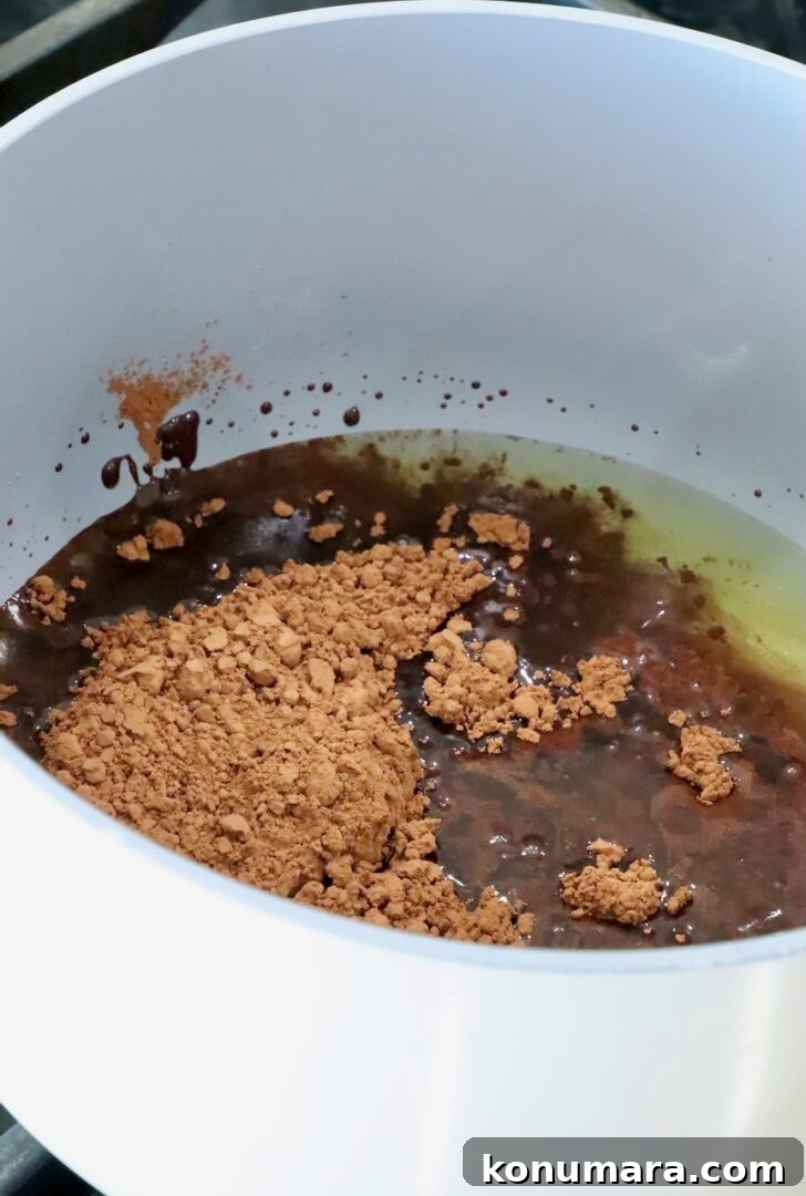 melted beef tallow and cocoa powder in a pot on the stove