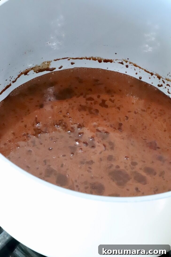 melted beef tallow combined with cocoa powder in a pot on the stove