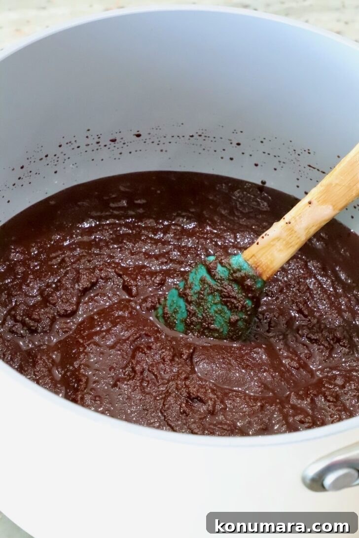 brownie batter in a pot with a spatula