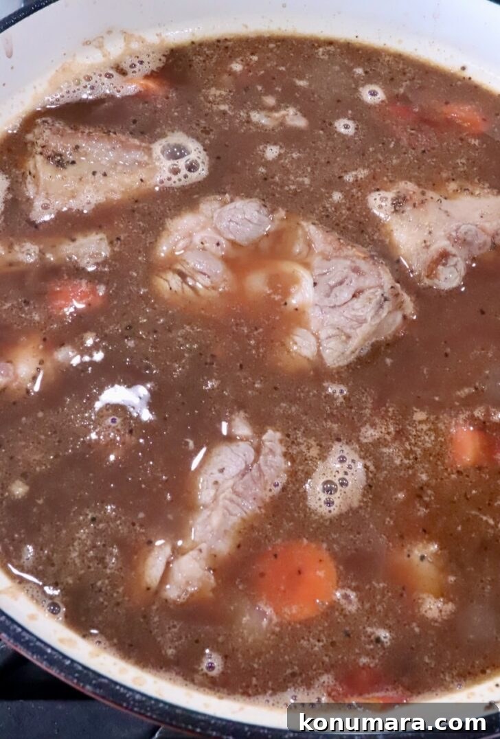 oxtail braising in red wine and beef broth