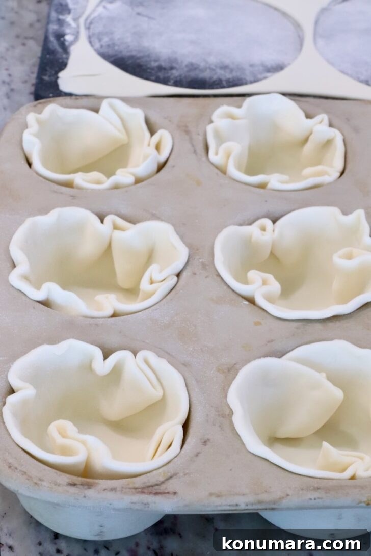 Braised Short Rib Pot Pie with French Onion 20 puff pastry dough circles pressed into a muffin tin